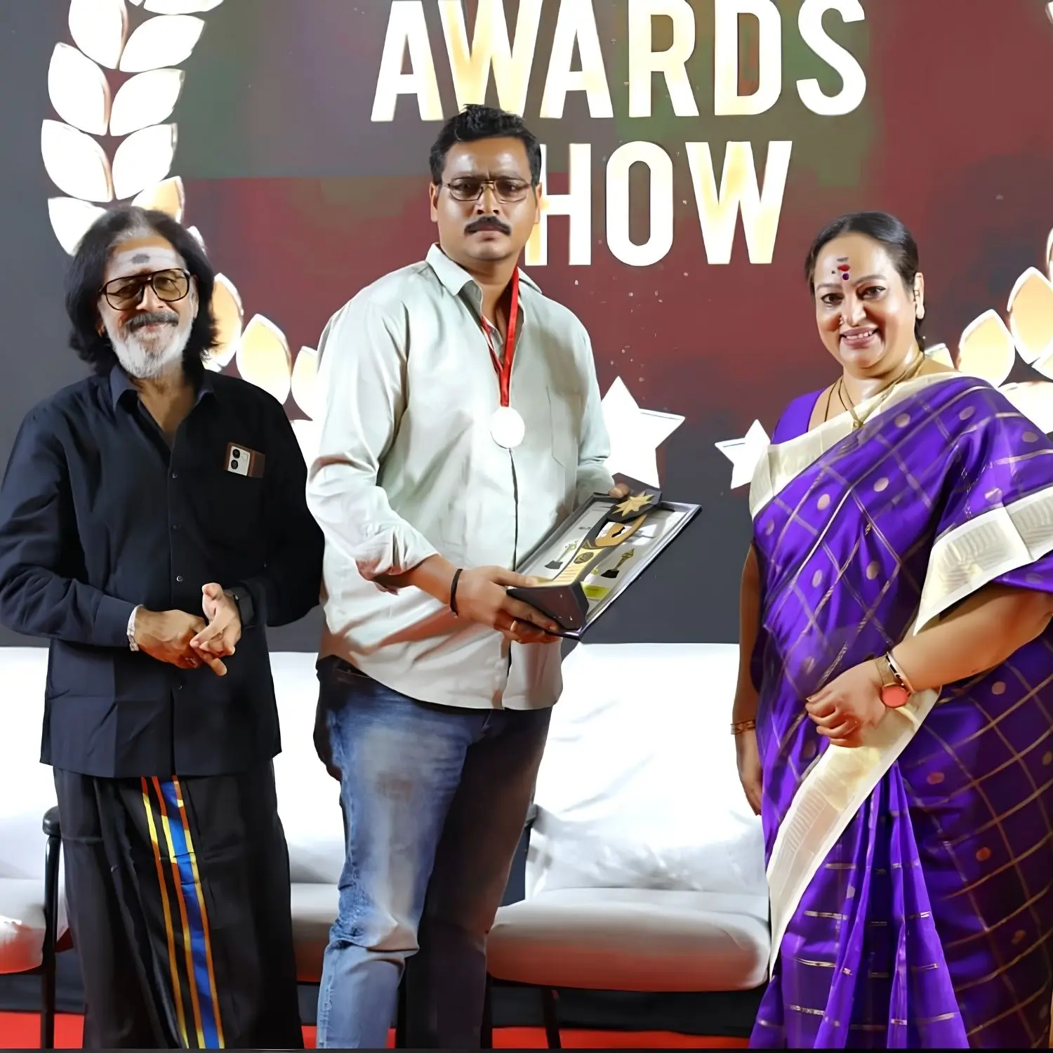 Sri Venkateswara Catering Service founder receiving an excellence award from actress Nalini, recognising the company's commitment to quality catering, hospitality, and exceptional customer service.
