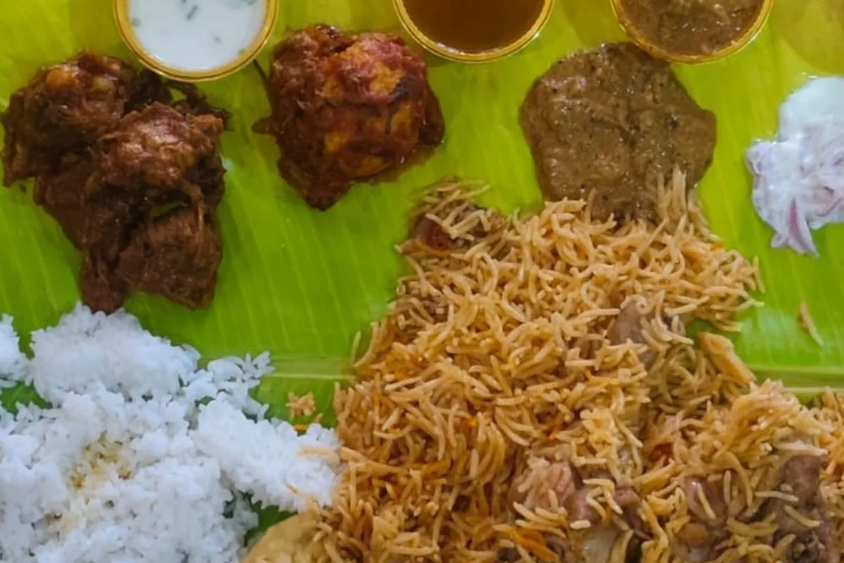 Bulk Biryani Order in Chennai — Veg &amp; Non-Veg - Sri Venkateswara Catering Service, Chennai — chicken biryani, fried chicken and sides served on a banana leaf