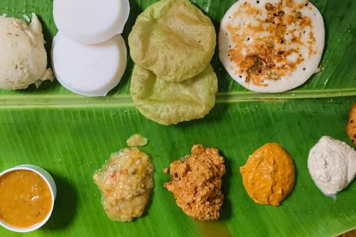 South Indian breakfast of idli, vada and chutneys on a banana leaf